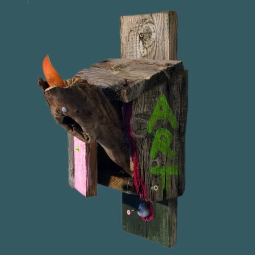 A TerribleistSculpture by Jack Myntan. An old crappy wooden birdbox hosts a old wooden (also crappy) creature with orange peel hair. On the sides it says Non Art in neon grean. The overall effect is repulsion.