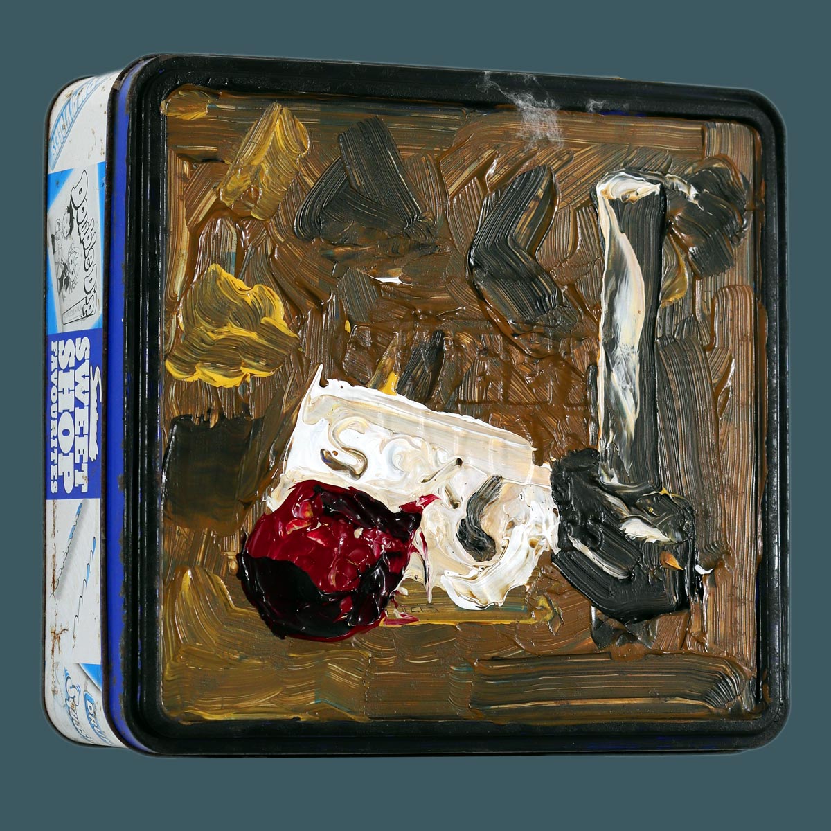 A Terribleist artwork by Jack Myntan featuring a small square tin with a painted lid showing abstract brown and beige forms suggesting the shapes of an onion, toilet roll, and mallet against an ochre background. This terrible art piece exemplifies the Terribleist movement's embrace of bad art and anti-perfectionism, with crude, immediate brushstrokes and a deliberately naive approach to representation that celebrates purposeful artistic failure and found object transformation.